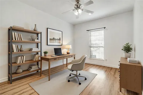 a workspace with wooden floor and a bookshelf