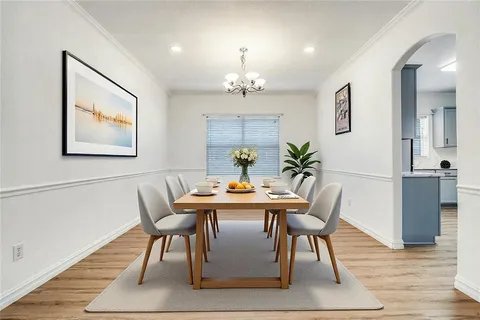 a view of a dining room with furniture wooden floor and chandelier