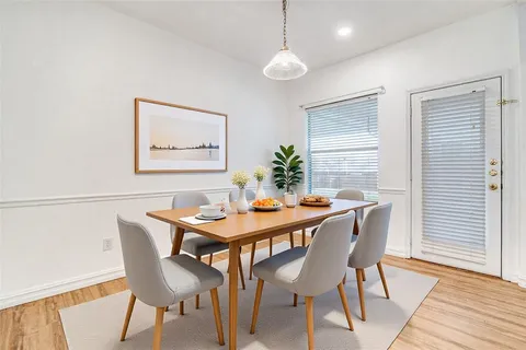 a dining room with furniture and wooden floor