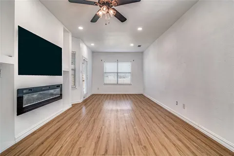 wooden floor in an empty room with a window
