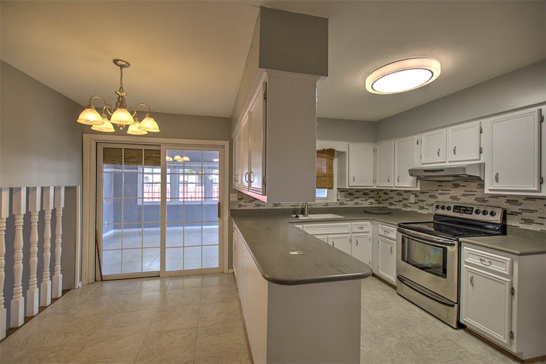 122 Bretton Court Decatur, IL 62521 - Photo 10 of 33 a kitchen with stainless steel appliances granite countertop a stove and a sink