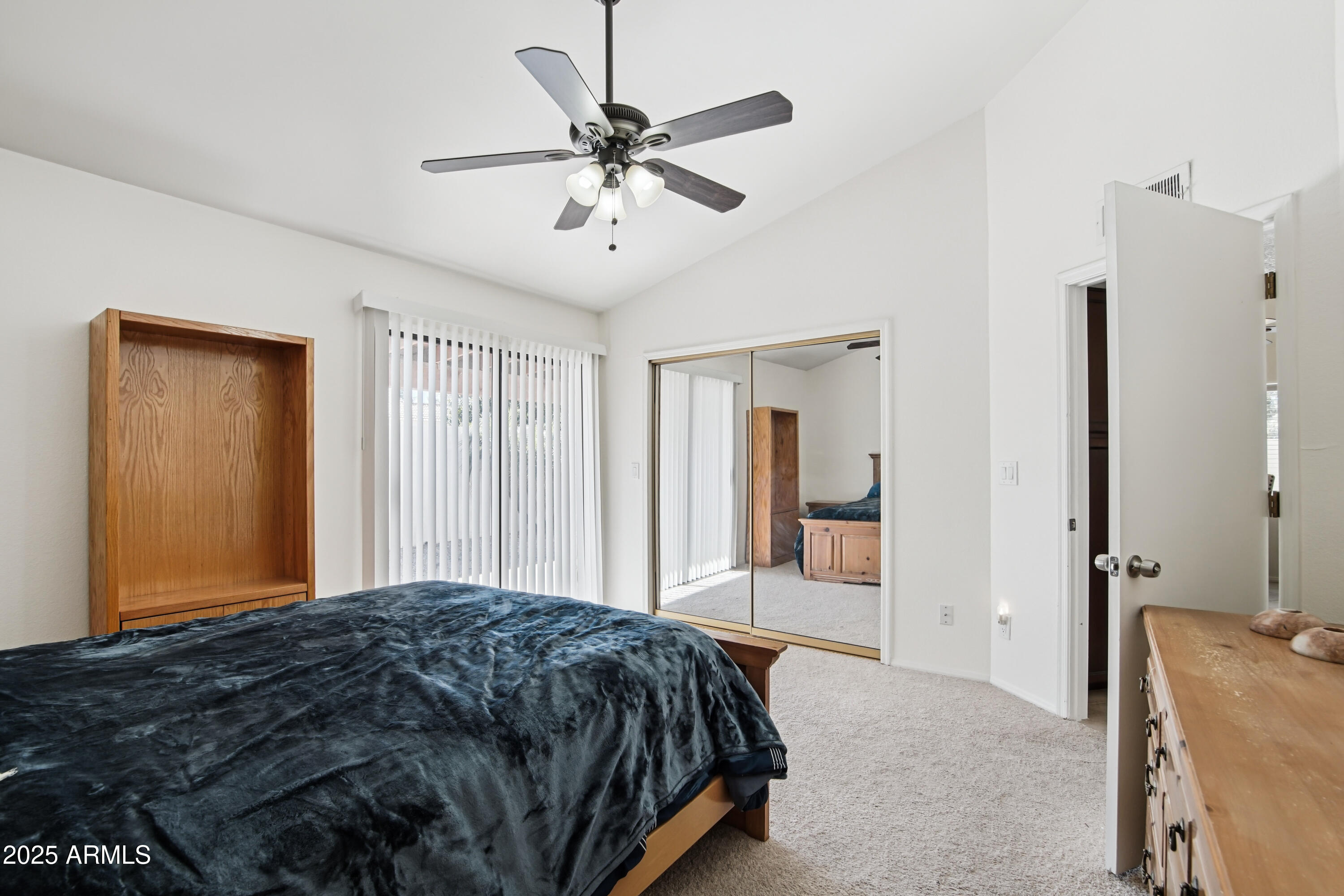 542 South Higley Road, Unit 89 Mesa, AZ 85206 - Photo 15 of 30 a bedroom with a bed and a chandelier