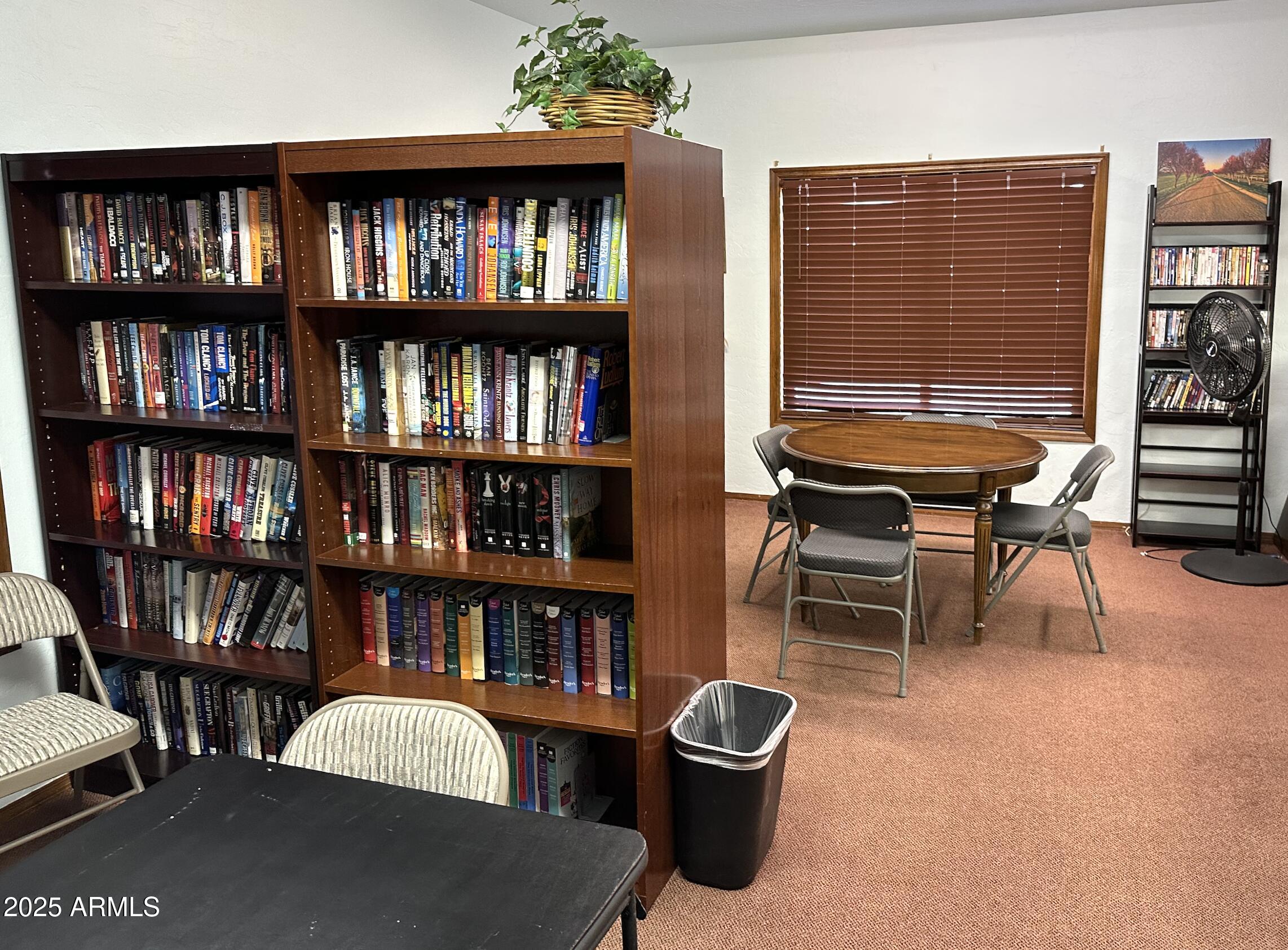 542 South Higley Road, Unit 89 Mesa, AZ 85206 - Photo 28 of 30 a living room with furniture and a book shelf