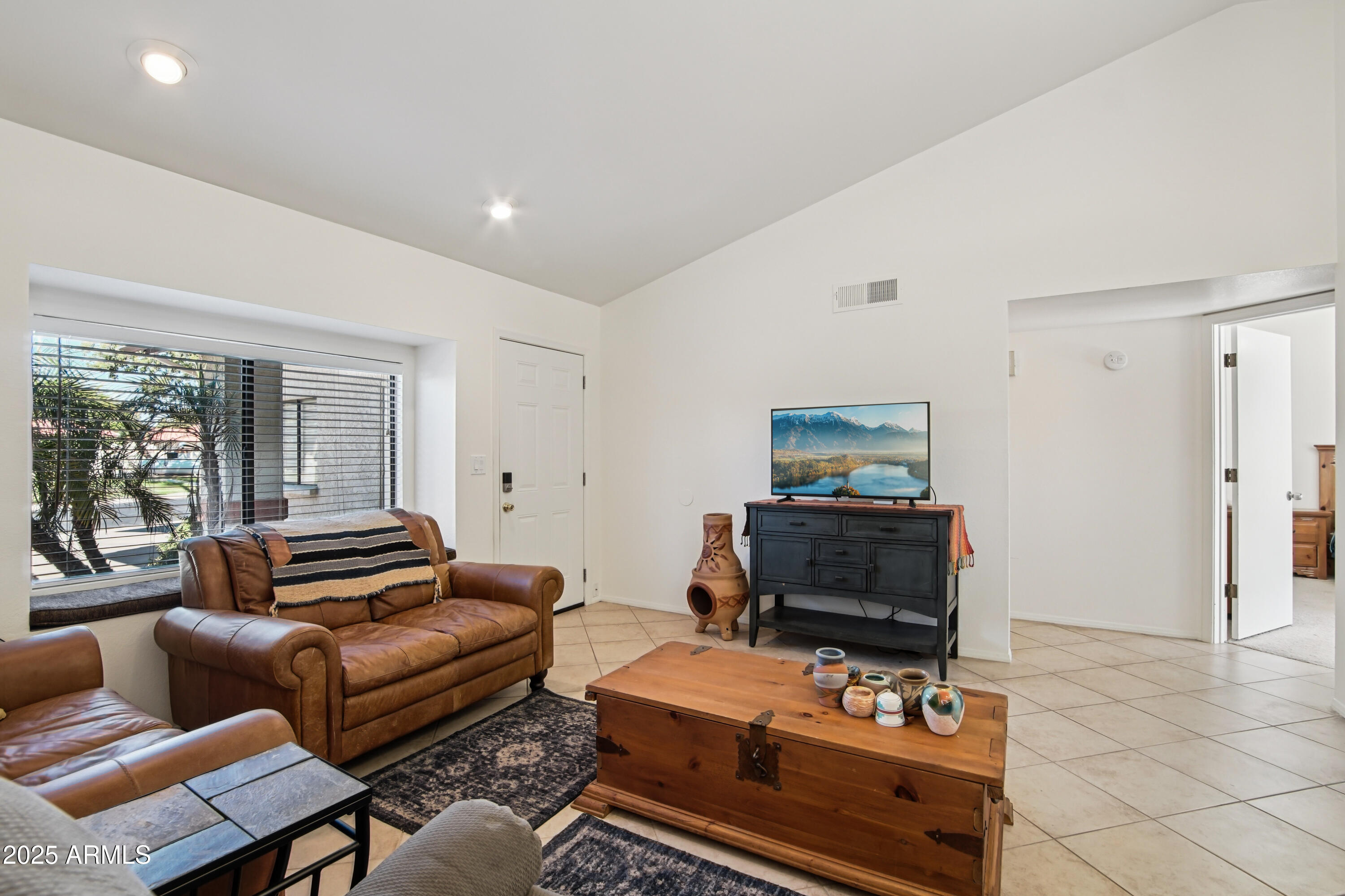 542 South Higley Road, Unit 89 Mesa, AZ 85206 - Photo 8 of 30 a living room with furniture and a flat screen tv