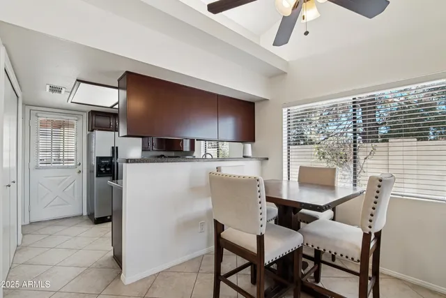 a view of kitchen with furniture and a refrigerator