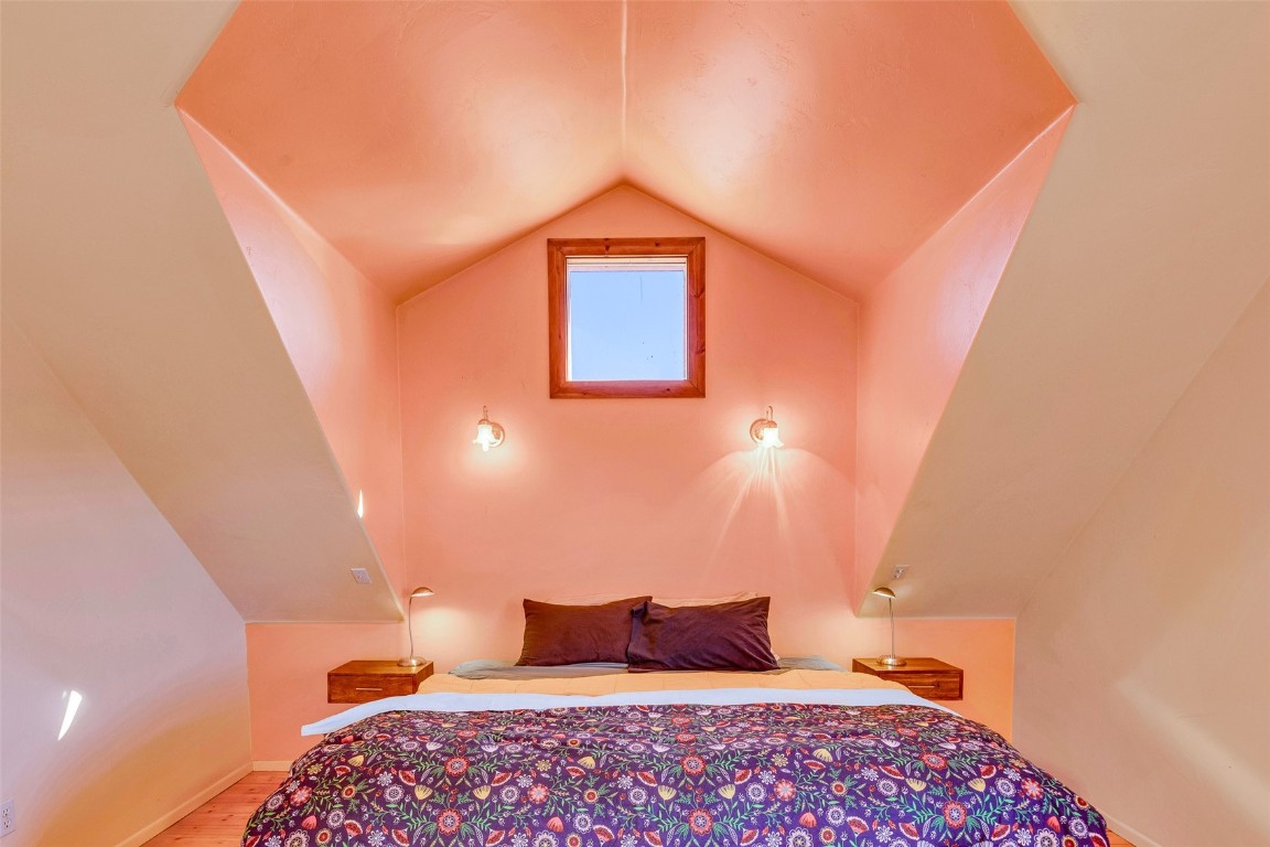 1528 Silver Heels Road Fairplay, CO 80440 - Photo 14 of 50 a bedroom with a bed and a lamp with the wall