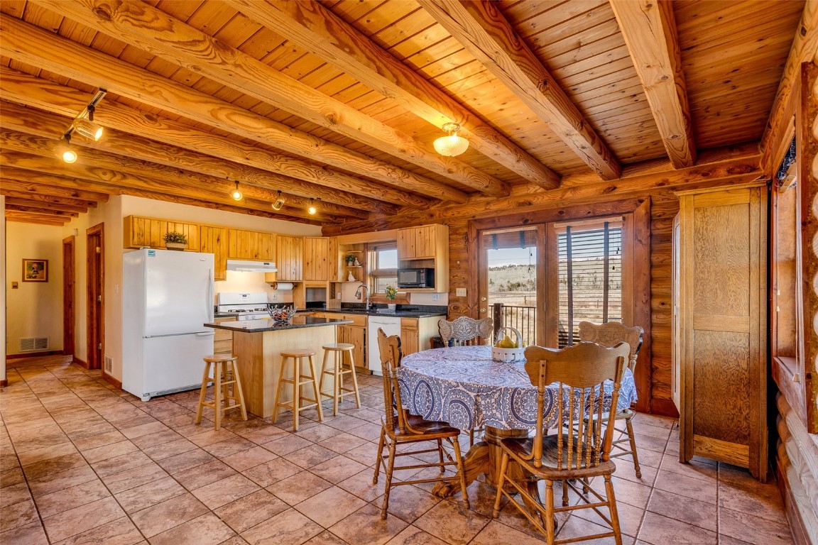 1528 Silver Heels Road Fairplay, CO 80440 - Photo 33 of 50 a dining room with furniture and a kitchen view