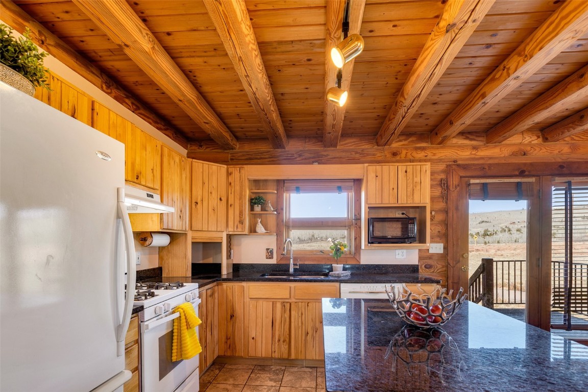 1528 Silver Heels Road Fairplay, CO 80440 - Photo 35 of 50 a view of a kitchen with stainless steel appliances wooden floor large windows
