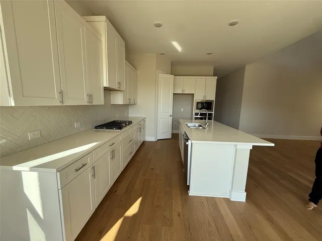 a kitchen with a sink and a refrigerator