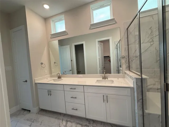 a bathroom with a double vanity sink and mirror