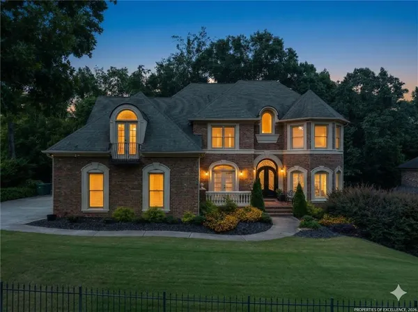 a front view of house with yard and green space