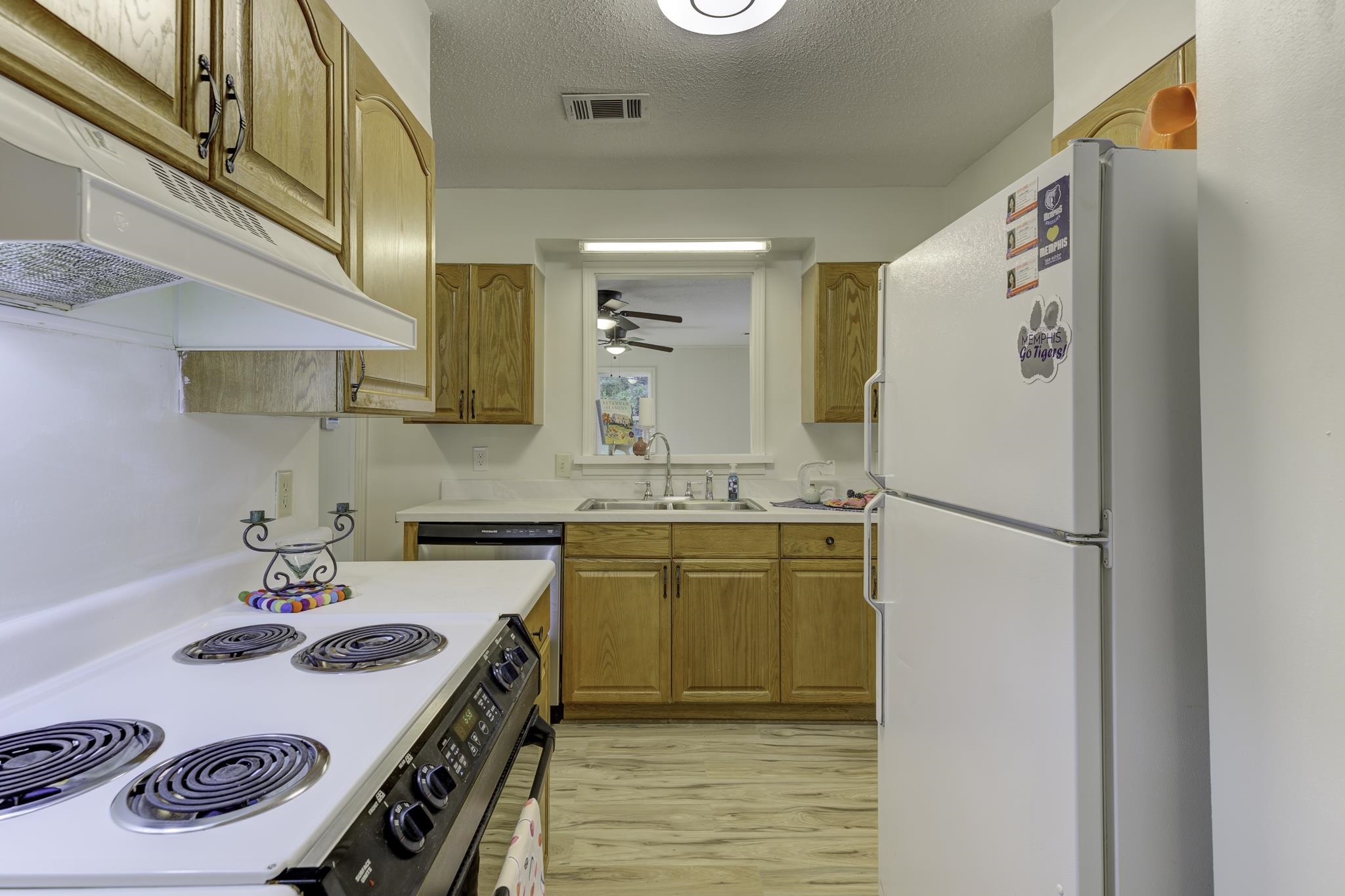 5077 New Castle Road Memphis, TN 38117 - Photo 12 of 37 a kitchen with a sink a refrigerator and a stove