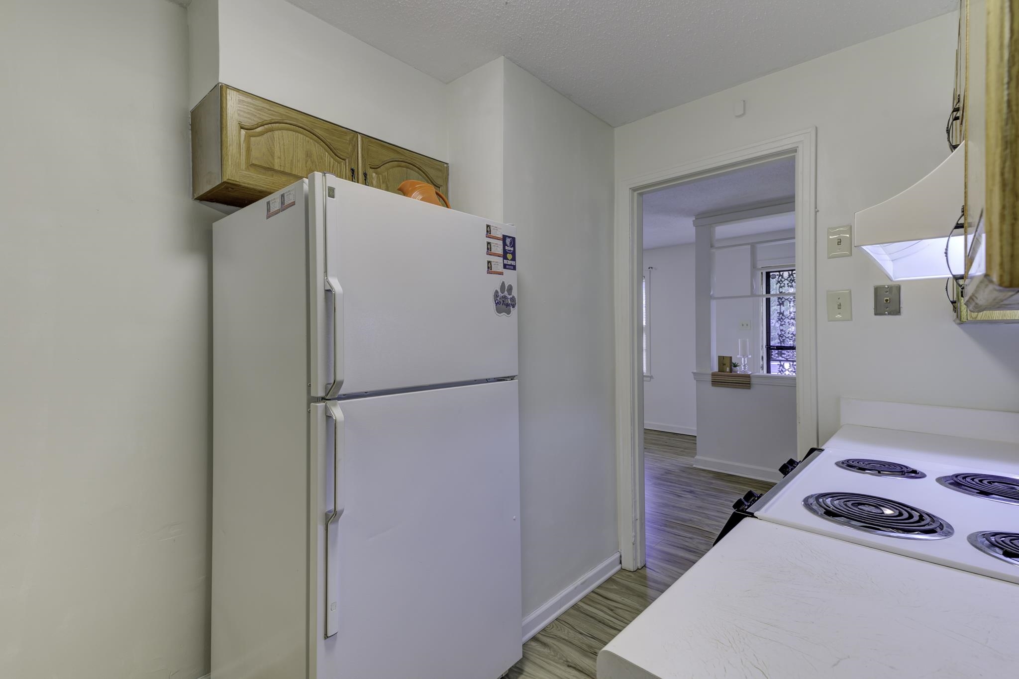 5077 New Castle Road Memphis, TN 38117 - Photo 19 of 37 a bedroom with a bed and a refrigerator