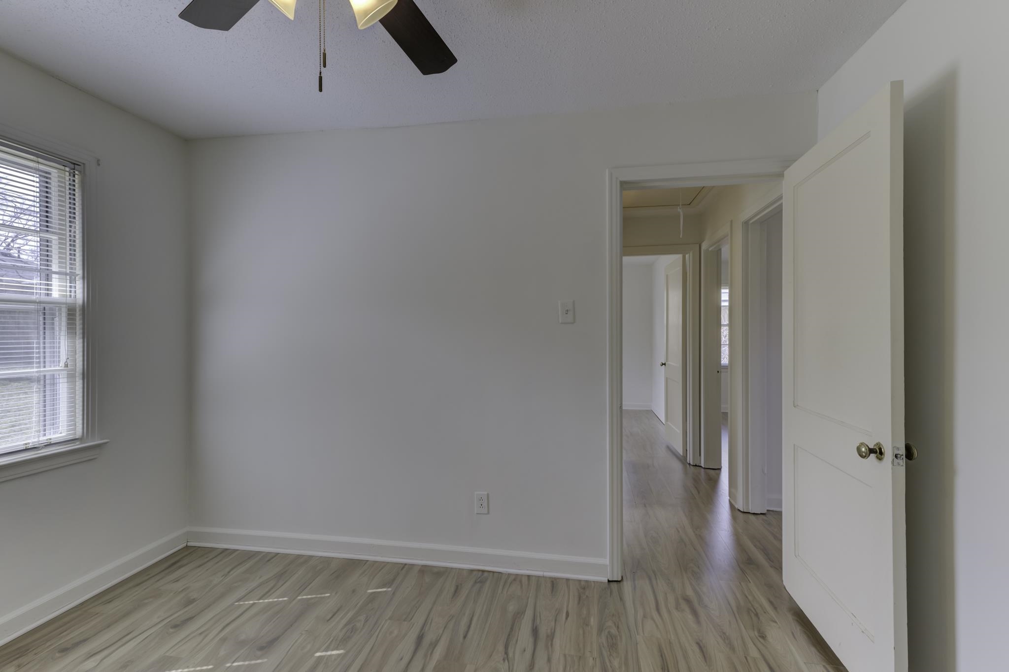 5077 New Castle Road Memphis, TN 38117 - Photo 21 of 37 wooden floor in an empty room with a window