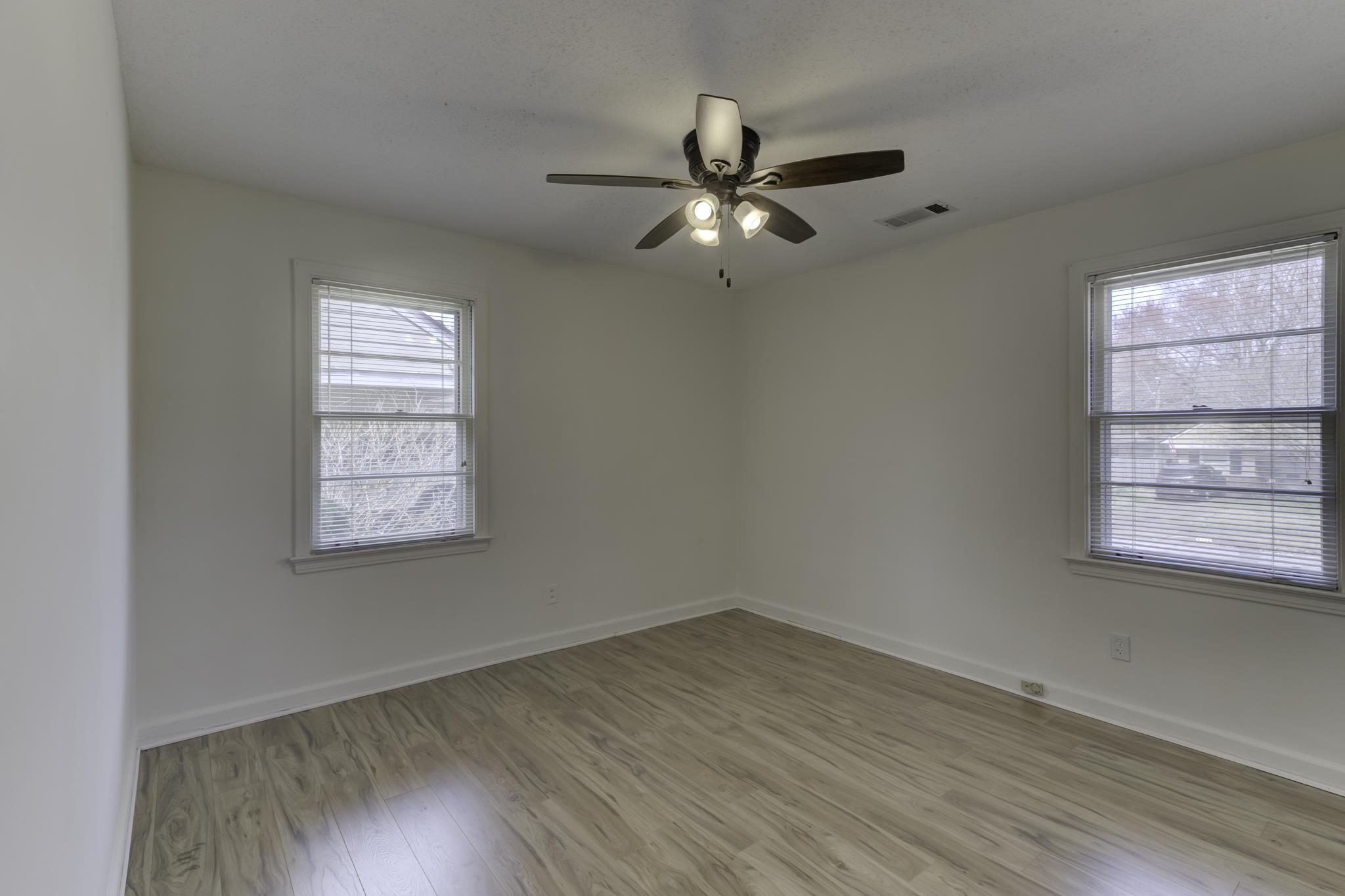 5077 New Castle Road Memphis, TN 38117 - Photo 26 of 37 wooden floor in an empty room with a window