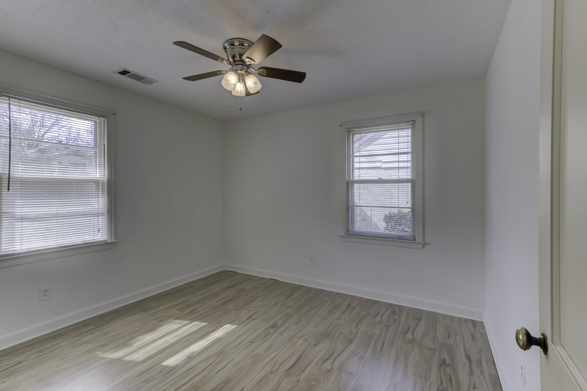 5077 New Castle Road Memphis, TN 38117 - Photo 28 of 37 wooden floor in an empty room with a window