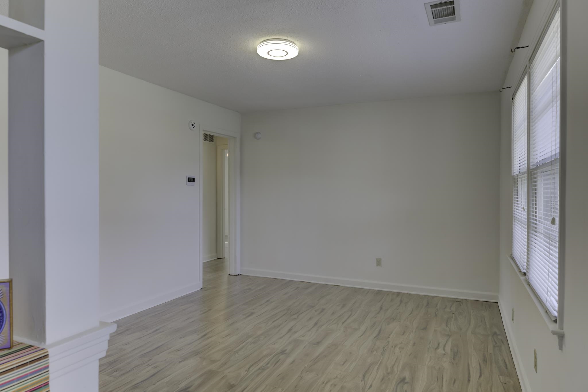 5077 New Castle Road Memphis, TN 38117 - Photo 6 of 37 a view of room with window and hardwood floor