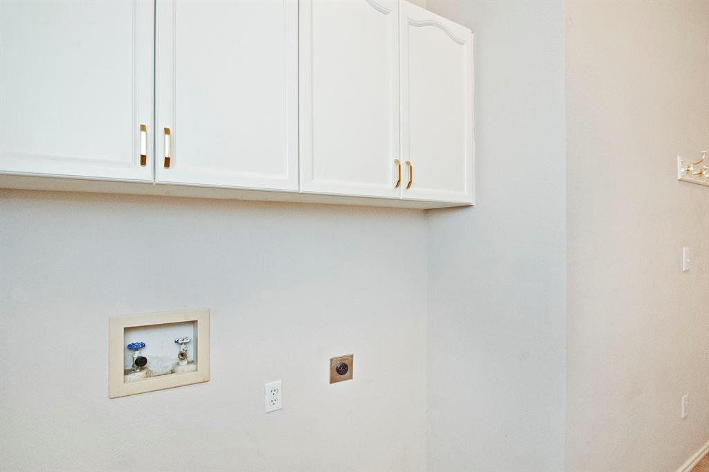 7757 Lancelot Road Frisco, TX 75035 - Photo 24 of 27 Clothes washing area with cabinet space, hookup for an electric dryer, and washer hookup