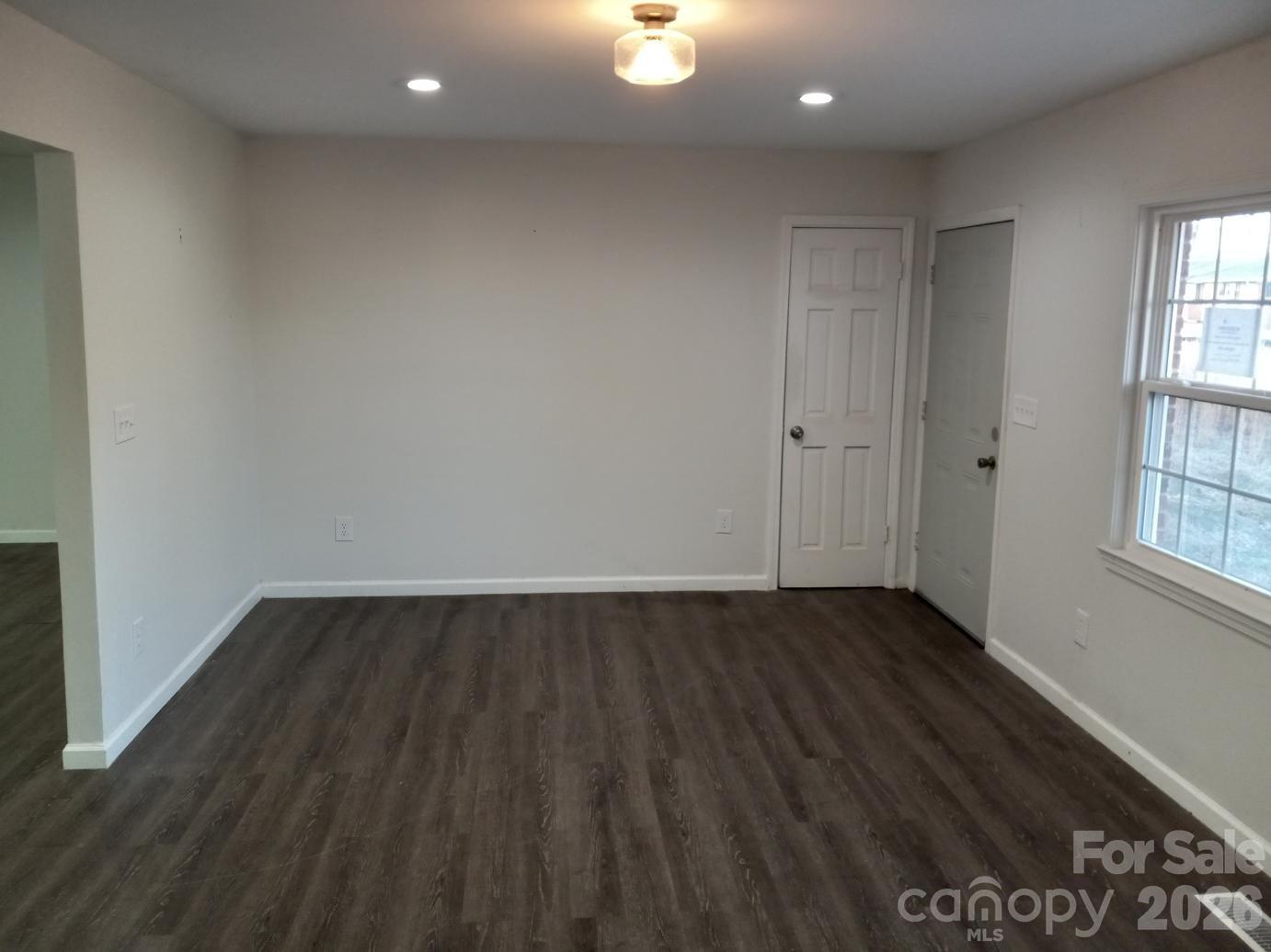 1110 Cherry Mountain Road Shelby, NC 28150 - Photo 3 of 19 a view of an empty room with wooden floor and a window