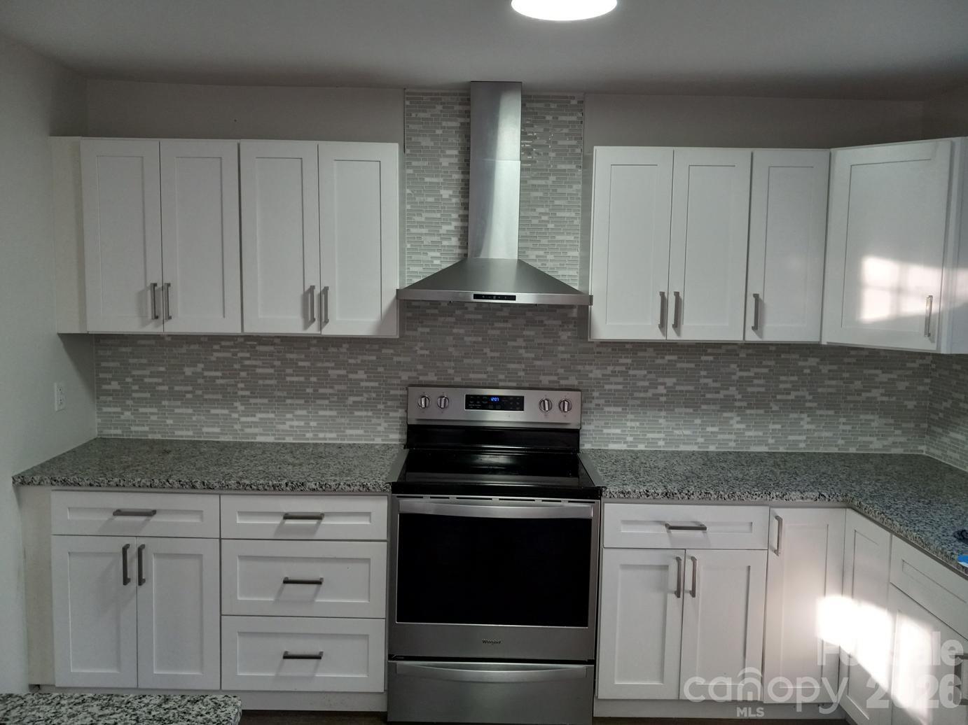 1110 Cherry Mountain Road Shelby, NC 28150 - Photo 7 of 19 a kitchen with granite countertop white cabinets and black appliances