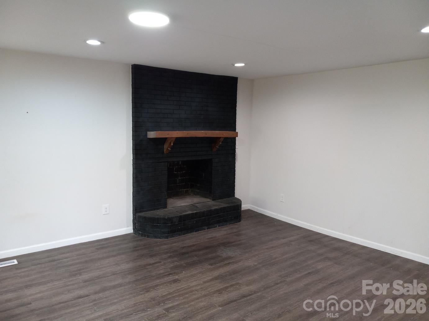 1110 Cherry Mountain Road Shelby, NC 28150 - Photo 9 of 19 a room with wooden floor and a fireplace