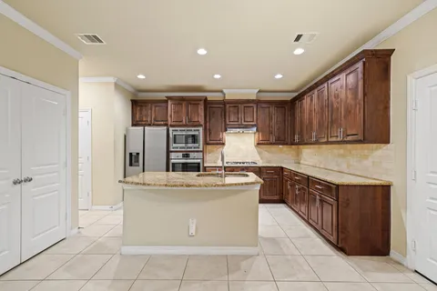 a kitchen with stainless steel appliances granite countertop a stove and a refrigerator