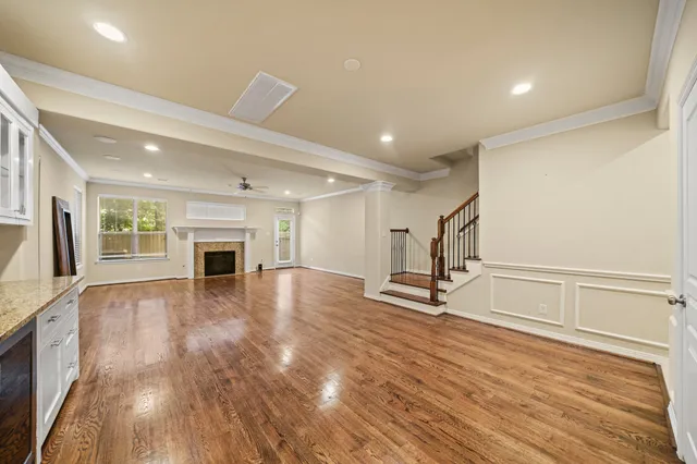 a view of empty room with wooden floor and fireplace