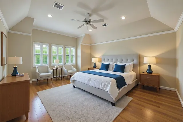 a spacious bedroom with a bed and a chandelier
