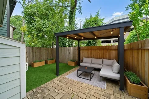 a backyard of a house with table and chairs