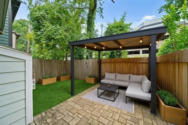 a backyard of a house with table and chairs