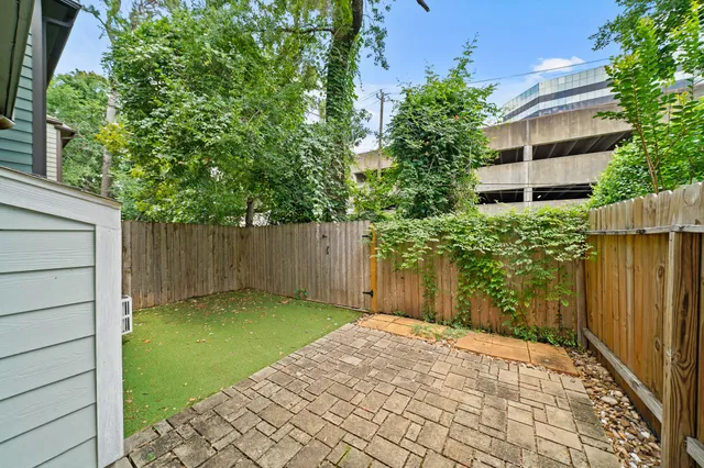 a backyard of a house with plants and trees