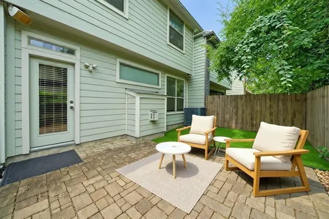 a white bench sitting in front of a house