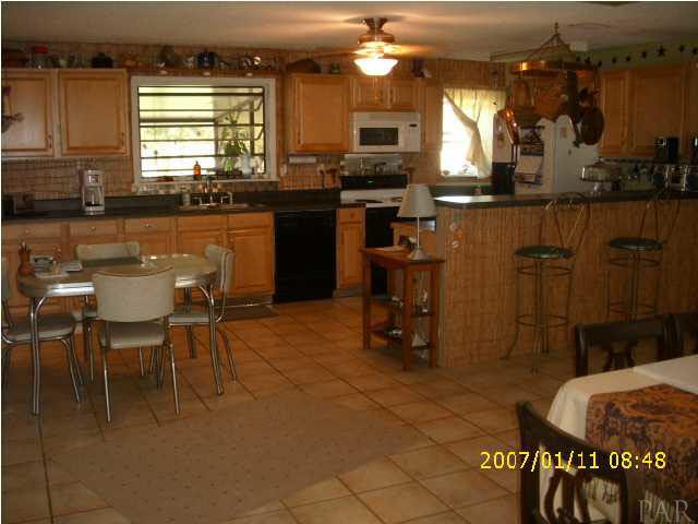 3333 Robinson Point Road Milton, FL 32583 - Photo 2 of 15 KITCHEN AREA W/BREAKFAST NOOK & BUILT IN BAR.
