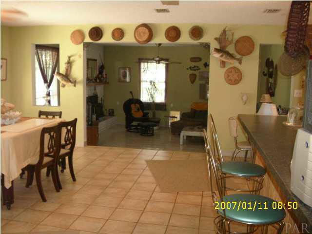 3333 Robinson Point Road Milton, FL 32583 - Photo 5 of 15 VIEW FROM HALL WAY - KITCHEN TO THE RIGHT, DINING ROOM TO THE LEFT, LIVING ROOM STRAIGHT AHEAD.