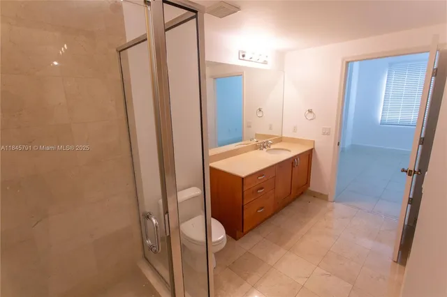 a spacious bathroom with a tub sink and mirror