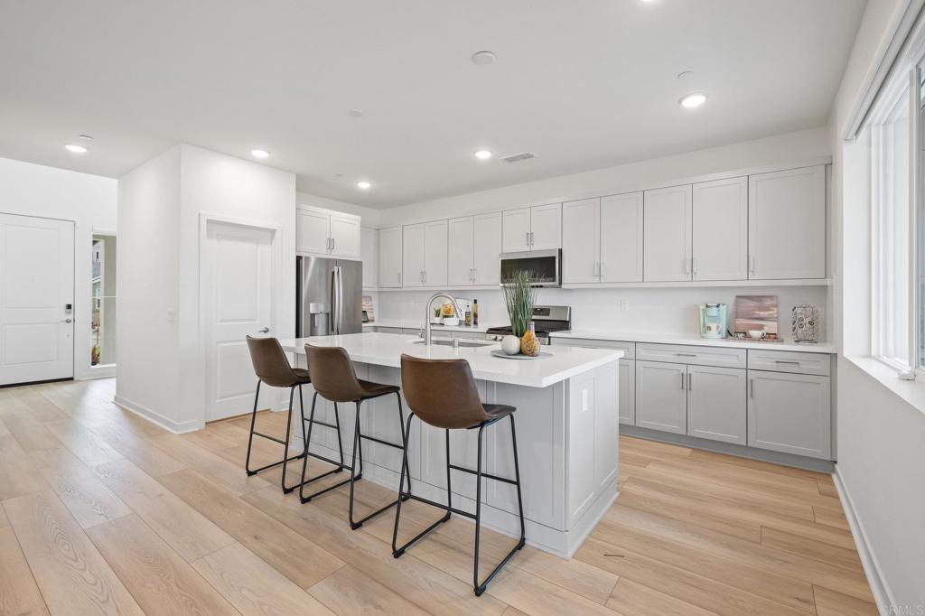 35152 Citrus Lane Fallbrook, CA 92028 - Photo 11 of 34 a kitchen with a sink cabinets and wooden floor