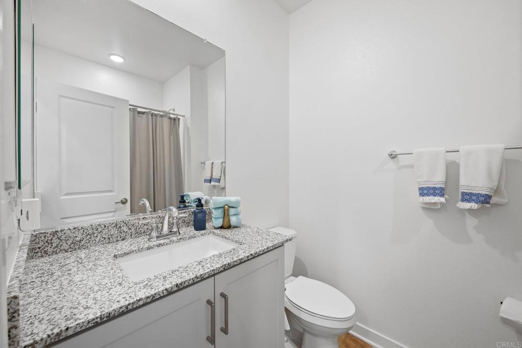 35152 Citrus Lane Fallbrook, CA 92028 - Photo 16 of 34 a bathroom with a granite countertop sink a toilet and mirror