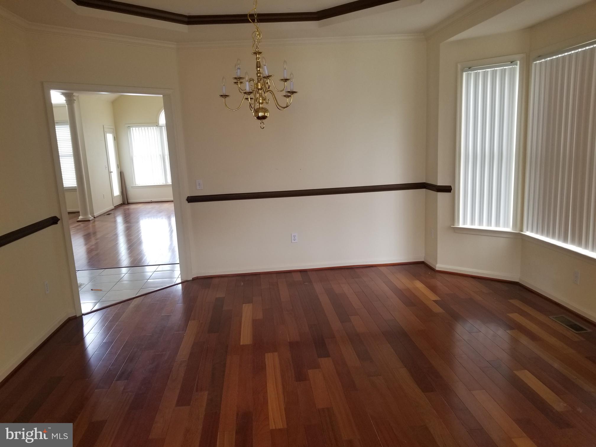 3943 Nelson House Road Ellicott City, MD 21043 - Photo 16 of 61 an empty room with wooden floor and windows