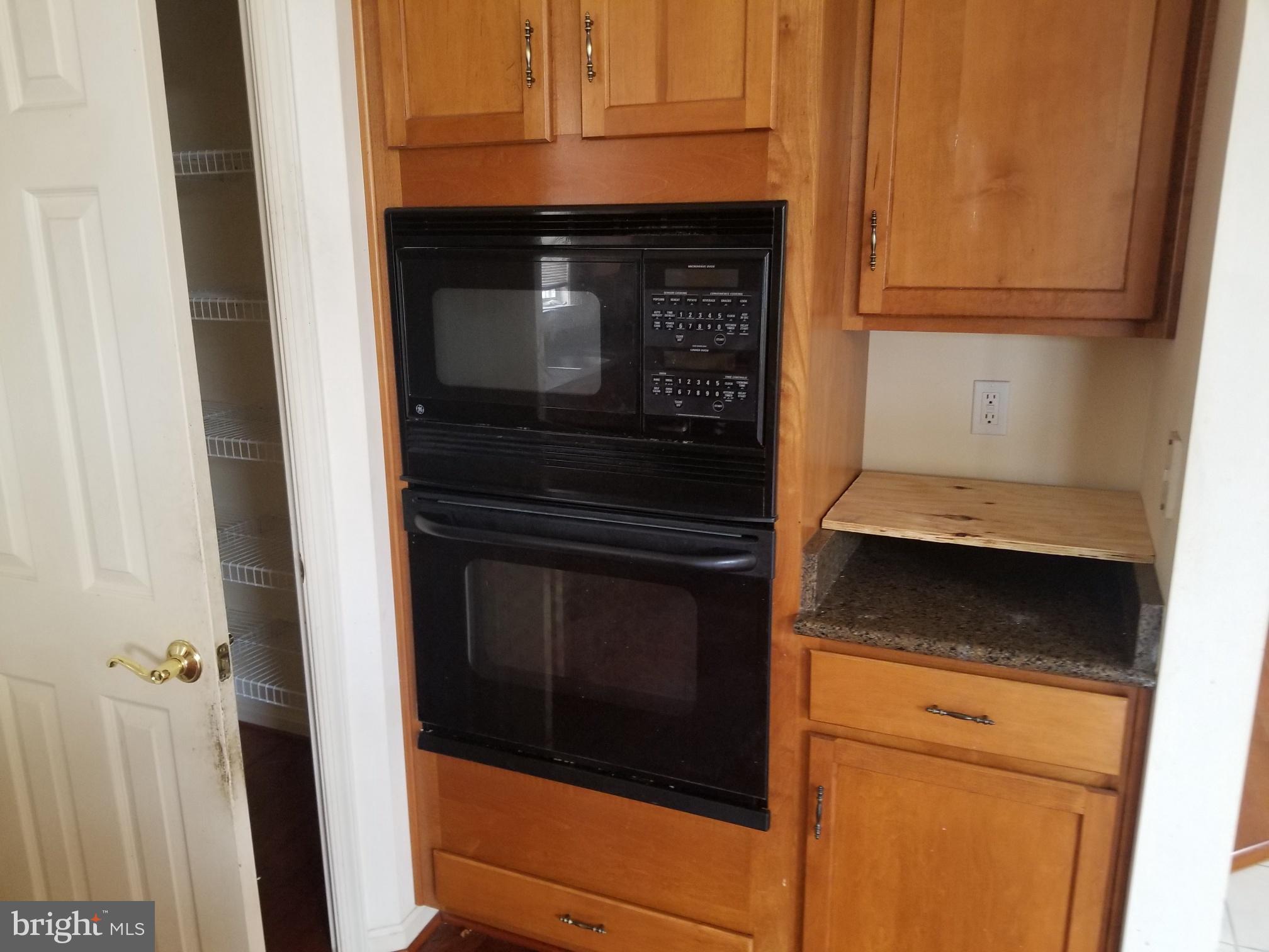 3943 Nelson House Road Ellicott City, MD 21043 - Photo 29 of 61 a kitchen with granite countertop white cabinets and black appliances