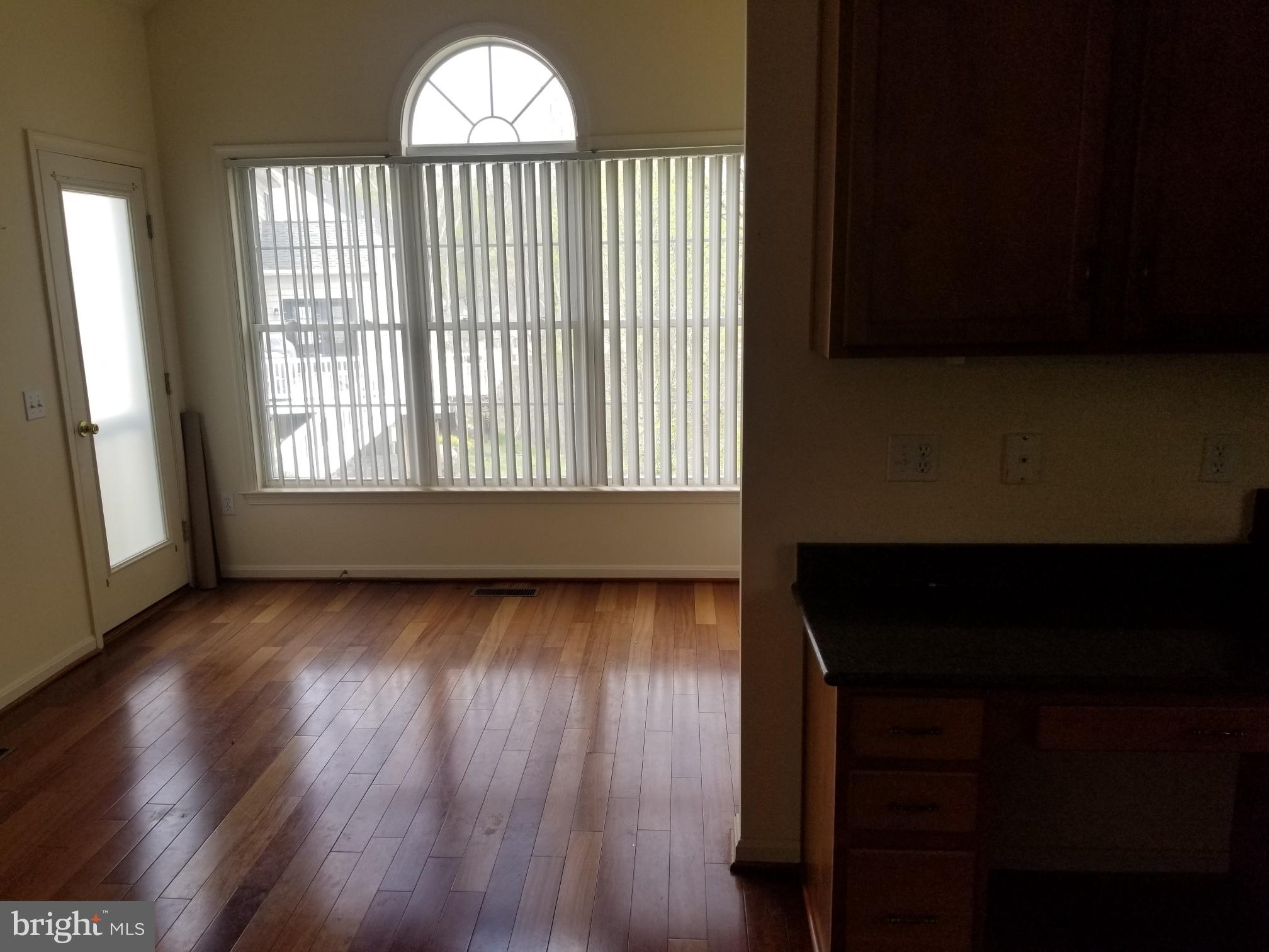 3943 Nelson House Road Ellicott City, MD 21043 - Photo 31 of 61 a view of an empty room with wooden floor and a window