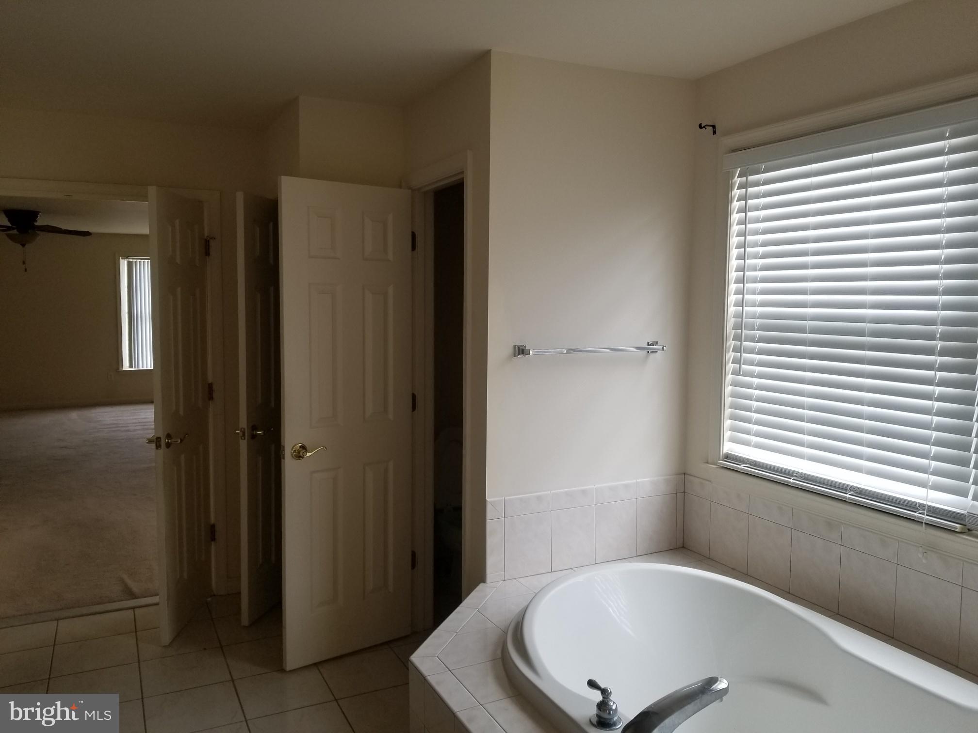 3943 Nelson House Road Ellicott City, MD 21043 - Photo 41 of 61 a bathroom with a tub shower and a sink