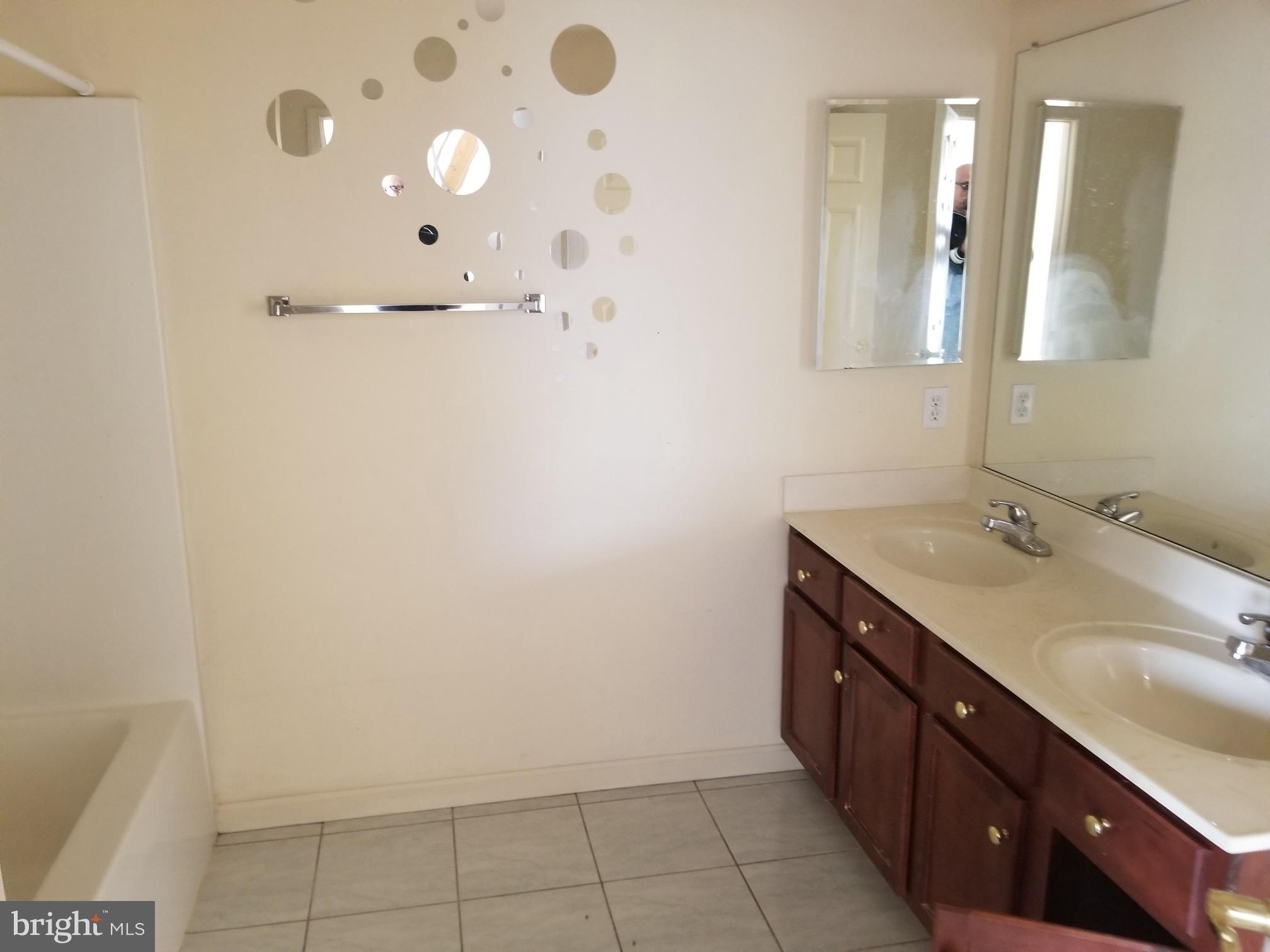 3943 Nelson House Road Ellicott City, MD 21043 - Photo 47 of 61 a bathroom with a double vanity sink and mirror