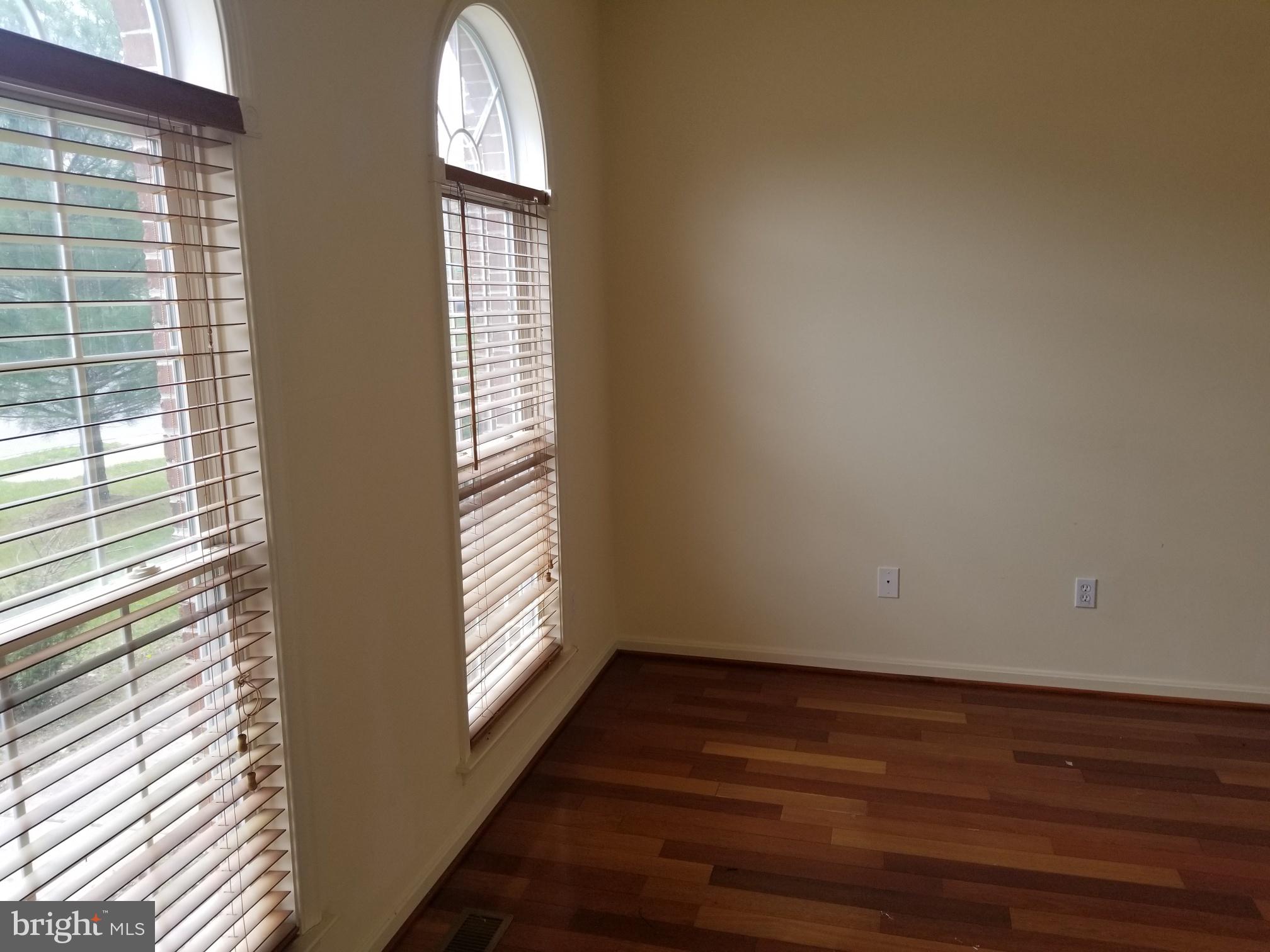 3943 Nelson House Road Ellicott City, MD 21043 - Photo 10 of 61 a view of an empty room with wooden floor and a window