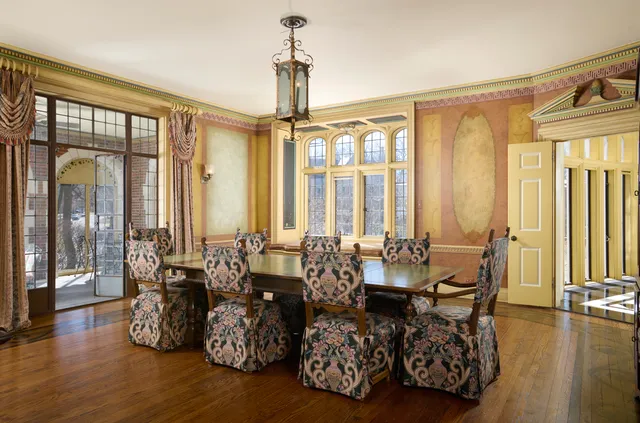 a living room with furniture and floor to ceiling windows