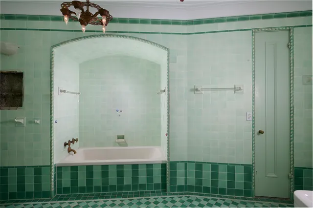 a bathroom with a window a sink and a mirror