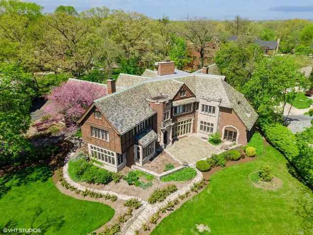 an aerial view of a house with yard and outdoor seating