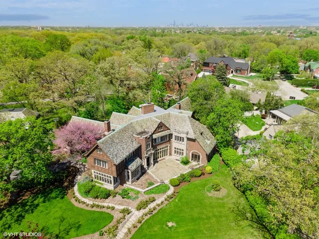 an aerial view of a house with a yard