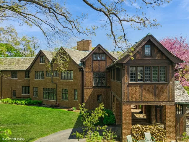 an aerial view of residential house with outdoor space and trees all around