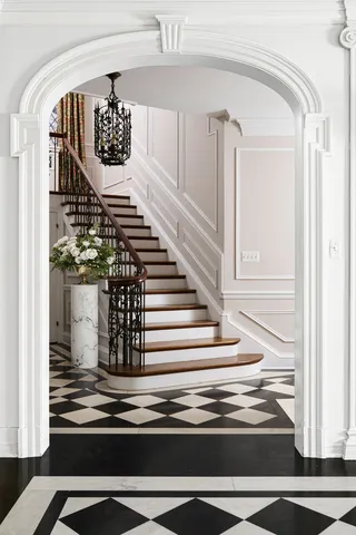 a room with a fireplace and a rug