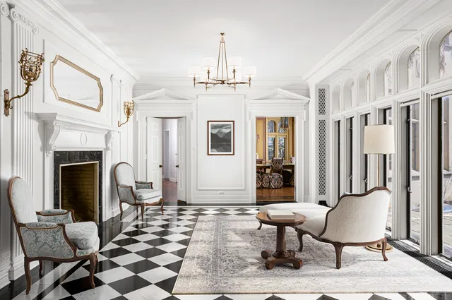 a view of a hallway with wooden floor and a fireplace